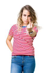 Beautiful young blonde woman over isolated background Showing middle finger, impolite and rude fuck...