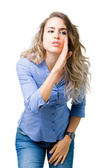 Beautiful young blonde business woman over isolated background hand on mouth telling secret rumor, whispering malicious talk conversation