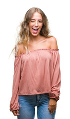 Beautiful young blonde woman over isolated background winking looking at the camera with sexy...