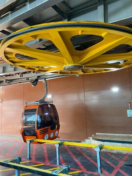 Large yellow bullwheel at a cable car station on the Tunektepe Cable Car in Antalya, Turkey