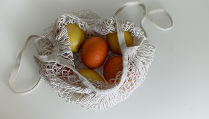 lemon and oranges in a shopping bag