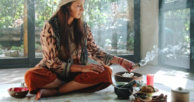 Woman, burning sage and ritual for healing, energy balance and shaman with natural medicine. Herbal, aromatherapy and traditional healer with incense smoke, spiritual and holistic ceremony for aura