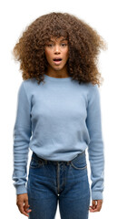 African american woman wearing a sweater afraid and shocked with surprise expression, fear and...