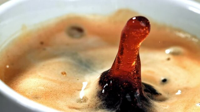 Close up of a cup of coffee with a hole in it, showcasing the liquid ingredient seeping out. A tempting sight for any terrestrial animal in need of comfort food
