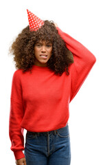 African american woman celebrates birthday stressed with hand on head, shocked with shame and surprise face, angry and frustrated. Fear and upset for mistake.