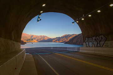 Tunnel exit overlooking Lake Potrerillos at dawn, in Mendoza, Argentina.