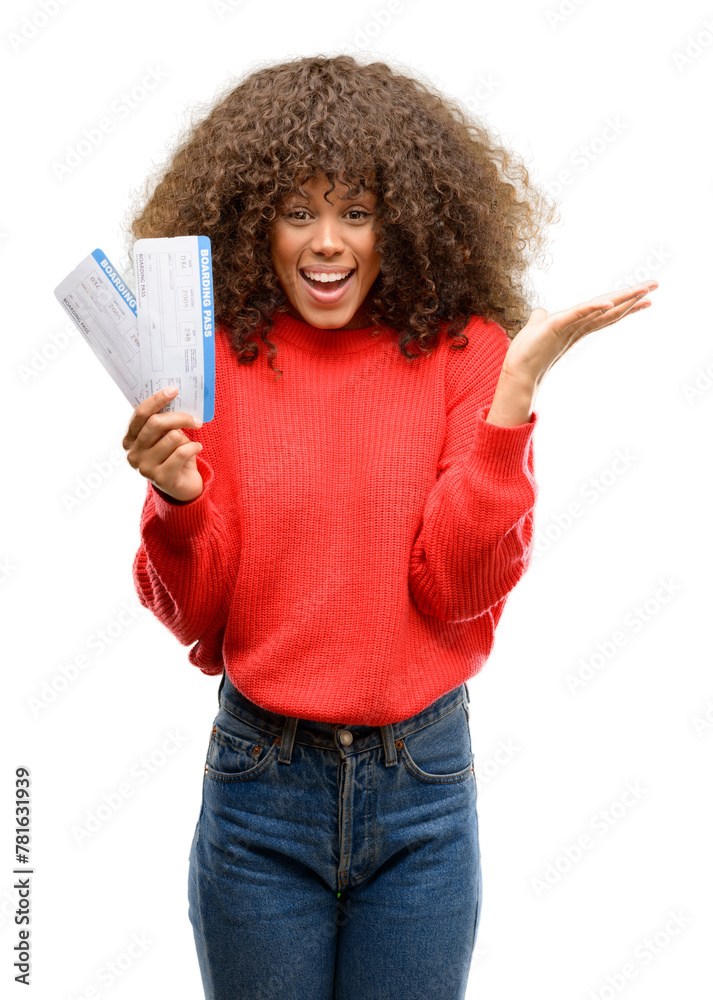 Wall mural African american woman holding airline boarding pass tickets very happy and excited, winner expression celebrating victory screaming with big smile and raised hands