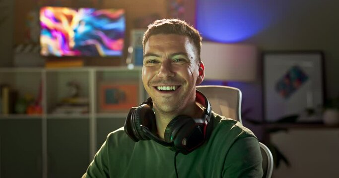 Gaming, video game and face of man at night for entertainment, online esports and development. Gamer, programming and portrait of person with headphones for virtual, streaming and competition in home