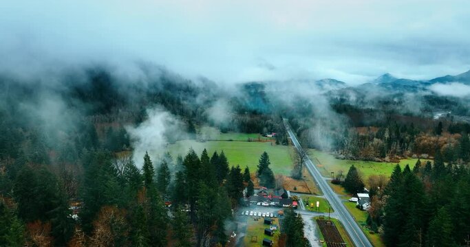 Cottages and parking lots in the valley of Mount Rainer national Park, Washington State, the USA. Top view on the misty forests covering the gorgeous mountains.