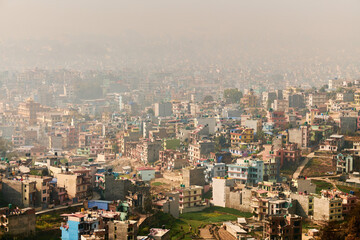 View of Kathmandu capital of Nepal from mountain through urban haze with lot of low rise buildings,...