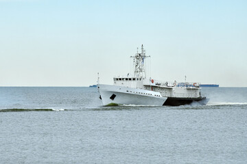 Coast guard ship sails along seaside for safeguarding coastal boundaries and maritime interests...