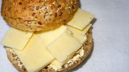 Tasty cheese in a seeded brown bread roll