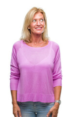 Fototapeta premium Middle age blonde woman over isolated background smiling looking side and staring away thinking.