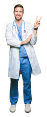 Handsome doctor man wearing medical uniform over isolated background smiling with happy face...