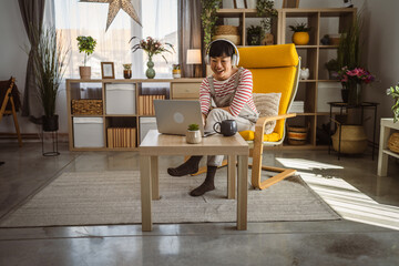 Japanese woman work at home with laptop and hold document