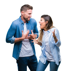 Young couple in love over isolated background crazy and mad shouting and yelling with aggressive...