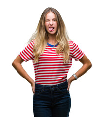 Fototapeta premium Young beautiful blonde woman over isolated background sticking tongue out happy with funny expression. Emotion concept.