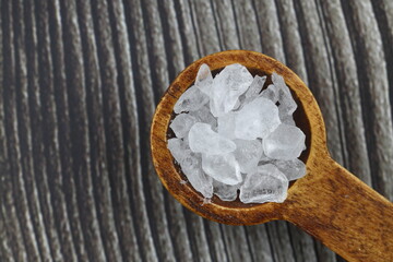 sea salt in a spoon isolated on black background