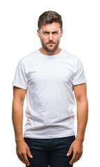Young handsome man over isolated background skeptic and nervous, frowning upset because of problem. Negative person.