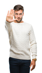 Young handsome man wearing winter sweater over isolated background doing stop sing with palm of the...