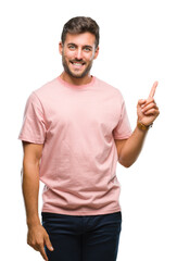 Fototapeta premium Young handsome man over isolated background with a big smile on face, pointing with hand and finger to the side looking at the camera.
