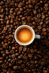 Fototapeta premium Freshly Brewed Coffee in a Black Cup Surrounded by Coffee Beans