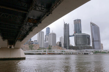 Brisbane river with bridge & city skyline buildings .