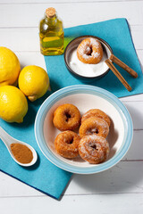 Homemade doughnuts fried with sugar, cinnamon and lemon.