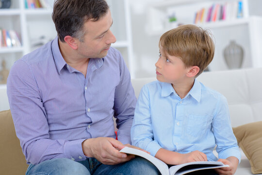 dad and his son reading a book