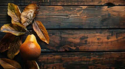 Close-up of pear on branch with leaves on wooden background