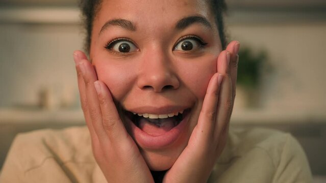 Close up happy woman African American ethnic girl shocked amazed astonished face expression open mouth big eyes wow shock reaction female home owner lady businesswoman surprise wonder amaze indoors
