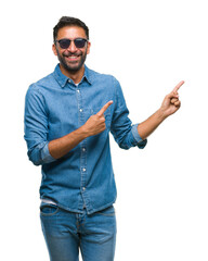 Adult hispanic man wearing sunglasses over isolated background smiling and looking at the camera...