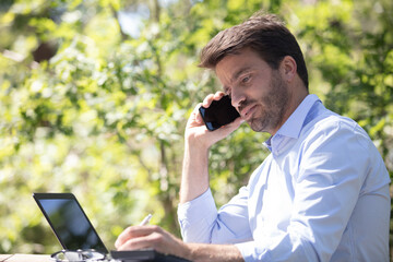 male white-collar worker making phonecall outdoors - obrazy, fototapety, plakaty