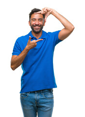 Fototapeta premium Adult hispanic man over isolated background smiling making frame with hands and fingers with happy face. Creativity and photography concept.