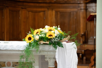 elegant floral arrangement with sunflowers on altar for wedding ceremony
