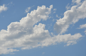 Clouds in a bright blue sky at midday