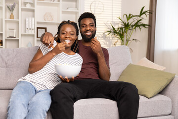 Couple Enjoying Movie At Home With Snacks