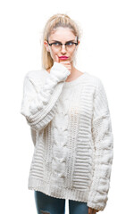 Young beautiful blonde woman wearing glasses over isolated background looking confident at the...