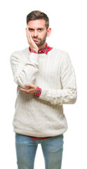 Young handsome man wearing winter sweater over isolated background thinking looking tired and bored...