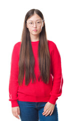 Obraz premium Young Chinese woman over isolated background wearing glasses with serious expression on face. Simple and natural looking at the camera.