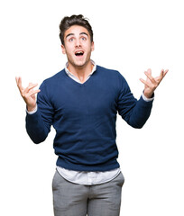 Fototapeta premium Young handsome business man over isolated background crazy and mad shouting and yelling with aggressive expression and arms raised. Frustration concept.