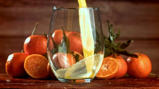 Super slow motion Fresh tangerine juice. High quality FullHD footage