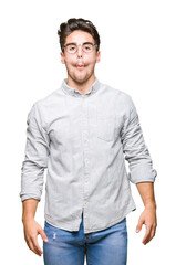 Obraz premium Young handsome man wearing glasses over isolated background making fish face with lips, crazy and comical gesture. Funny expression.