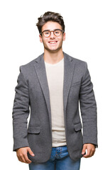 Fototapeta premium Young business man wearing glasses over isolated background with a happy and cool smile on face. Lucky person.