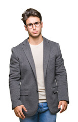 Young business man wearing glasses over isolated background depressed and worry for distress, crying angry and afraid. Sad expression.