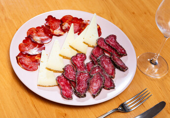 Appetizing cold cuts from sausage, cheese and ham on serving plate