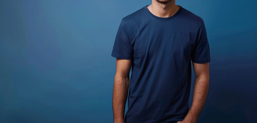 In sharp HD quality, a man wearing a half-sleeve navy blue t-shirt stands against a flat dark blue background, his confident demeanor and casual style effortlessly captured by the camera