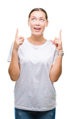 Young beautiful caucasian woman over isolated background amazed and surprised looking up and pointing with fingers and raised arms.