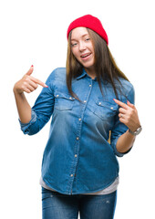 Young caucasian beautiful woman wearing wool cap over isolated background looking confident with smile on face, pointing oneself with fingers proud and happy.