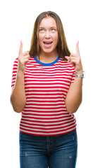 Young caucasian beautiful woman over isolated background amazed and surprised looking up and pointing with fingers and raised arms.